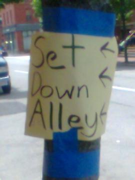 The USurrogates - Sign directing one to back alley set.